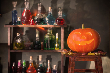 Halloween decoration with pumpkins and magic potions indoor