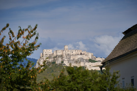 Ruins of the Spisky hrad in eastern slovakia, one of the larges castle sites in central europe included in the UNESCO list of World Heritage Sites, picture taken from garden in city Spiske podhradie.