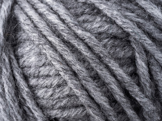 Macro photo of a skein of gray wool for knitting.