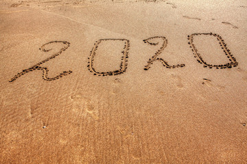 new year inscription on the sandy beach