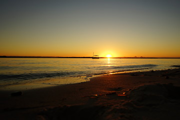 sun setting over calm water