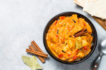 Chicken tikka masala with rice on black top view.