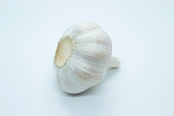 The head of garlic is located on a white background