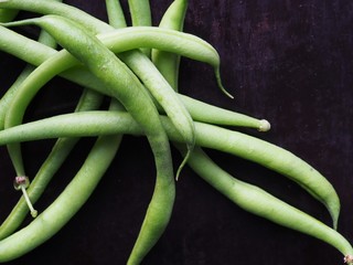 green beans on black background