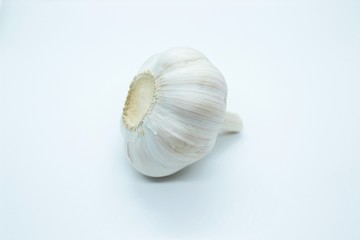 Obraz na płótnie Canvas The head of garlic is located on a white background