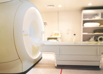 MRI or Magnetic resonance imaging scanner machine in Hospital isolated on  blurred MRI Room background.