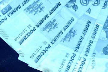 Banknote background from Russian rubles close up. Blue color toned