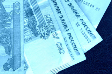 Banknote background from Russian rubles close up. Blue color toned
