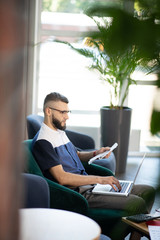 Businessman working on laptop sitting in nice office
