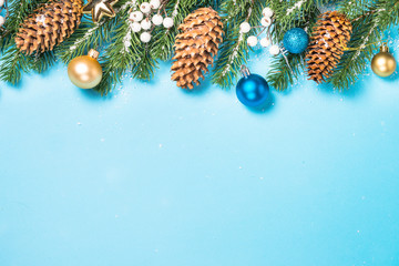 Christmas flatlay background - fir tree and decorations on blue