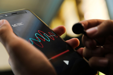 attractive hands playing music app on a smart phone