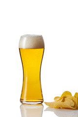 Perfect glass of beer with foam and potato chips on white background