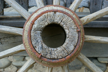 fragment of the old (vintage) wooden wheel. 19th century wagon wooden wheel. antique metal parts...