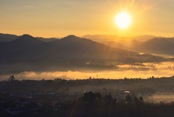 Inspiring sunset landscape, mountain view point. Looking and plain valley and village from hill...