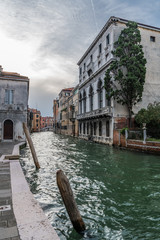 Naklejka premium Mooring posts at the embankment of the Venetian canal