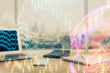 Forex Chart hologram on table with computer background. Multi exposure. Concept of financial markets.