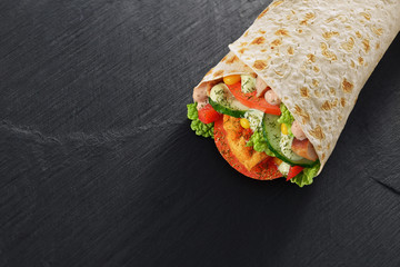 Wrap sandwich on dark black slate texture