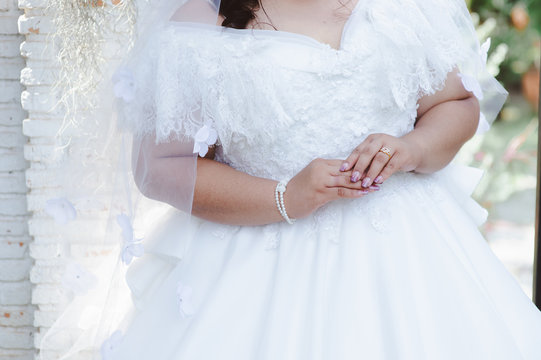 Happy overweight wedding dress and tuxedo or plus size newlywed or bride and groom take picture in bridal dress fitting room, healthy happy overweight newlywed concept