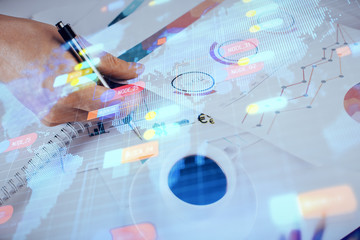 Writing man's hand with technology icons.