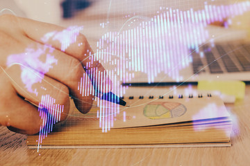 Double exposure of hands and notepad with business icons.
