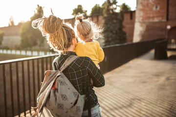 mom with dreadlocks hipster and toddler walk