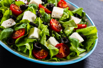 Greek salad on stone background
