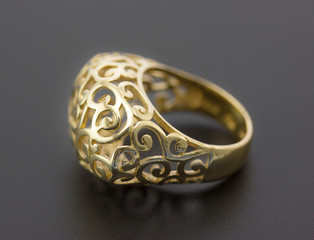 gold ring on a black background, close-up.