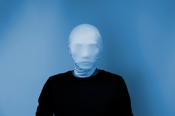 Man covering his face with white mask