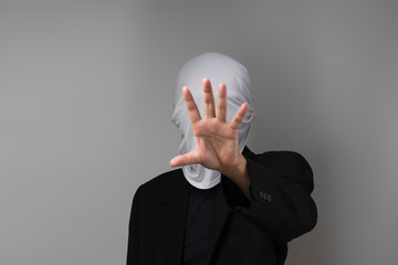 Man covering his face with white mask