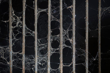 Abandon old prison rusted metal bars cell lock and cobweb or spider web, concept of strengthen and...