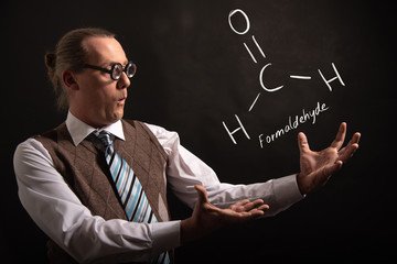 Professor presenting handdrawn chemical formula of Formaldehyde