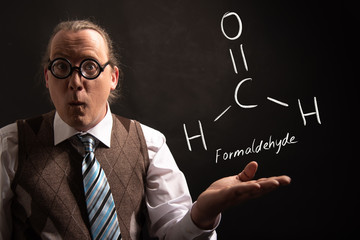 Professor presenting handdrawn chemical formula of Formaldehyde