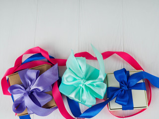 blue boxes with purple bows, Christmas presents on white background, copy space