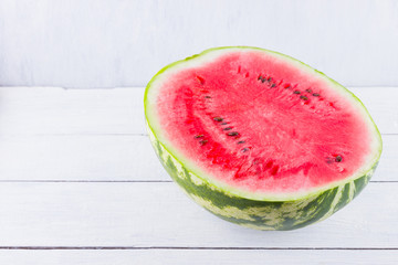 Half of watermelon on white background. Sliced watermelon on wooden boards. Healthy food for vegan. Top view