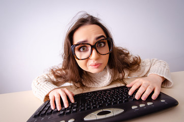 Funny nerd girl working on computer