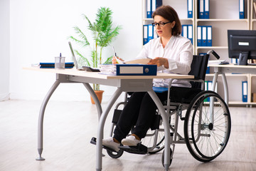 Female employee in wheel-chair at the office