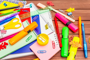 Back to school concept. School education supplies on brown wooden boards background