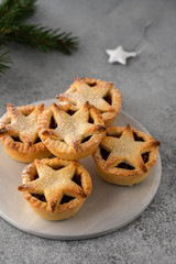 Delicious fruit mince tarts for Christmas dinner. Grey background, selective focus