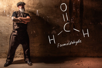 Bearded old man presenting handdrawn chemical formula of Formaldehyde