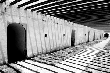 Abstract striped shadow against on wall of ancient fort.