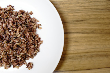 delicious brown cooked rice in white disk.