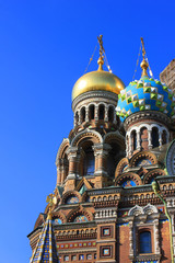 Fototapeta na wymiar Decorative onion domes of the Church of Our Savior on Spilled Blood in Saint Petersburg city, Russia 