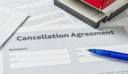 A Cancellation agreement with a pen on a desk