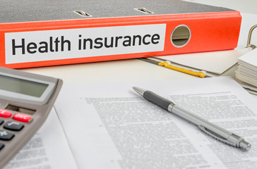 An orange folder with the label Health insurance