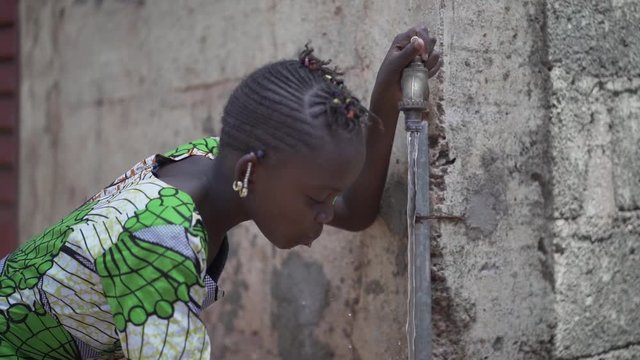 Human Rights and Climate Change Symbol: African Black Ethnicity Girl Woman Drinking Safe Water