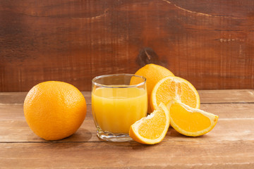 Oranges lie on a wooden table.