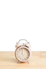 Alarm clock on table with white background.