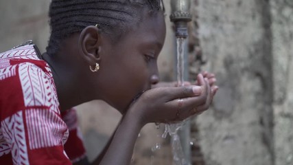 Water is Life for African Children, Little Gorgeous Black Girl Drinking from Tap