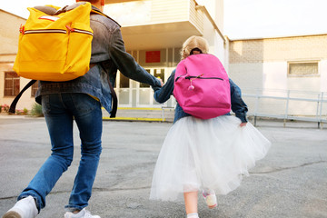 Boy with girl hold hand run to school