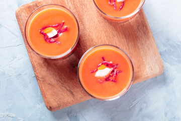 Salmorejo, Spanish cold tomato and bread soup, served in glasses, overhead close-up shot